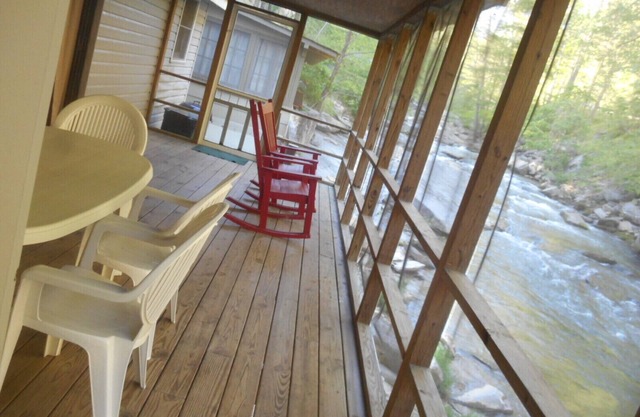 On the River's Edge!! Rocking chairs on large screened porch on river's edge.