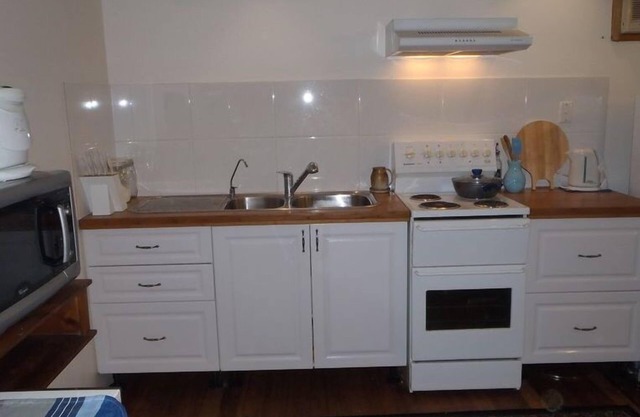 Open-plan living, ground level of two-storey house with sugar cane & rural views
