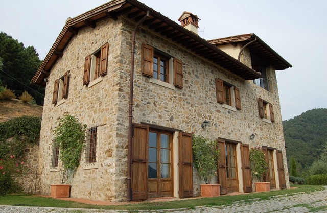 traditional Tuscan farmhouse set amongst terraced olive groves & pine forests