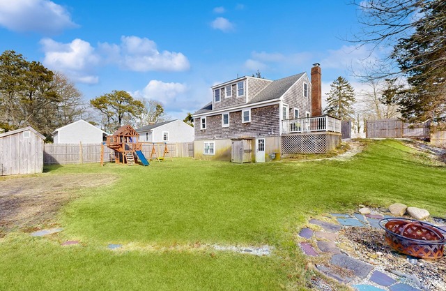 Two-story dog-friendly retreat with enclosed yard, playset, W/D, & firepit