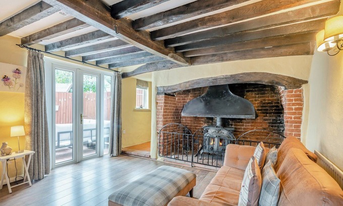 Saxthorpe Cabaña | A spacious, bright property with a large inglenook fireplace and lovely furnishings.