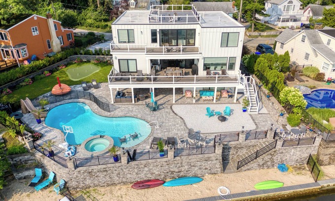 Osbornsville Casa | Beautiful waterfront 8-BR house w pool patio, outdoor bar, dock, putting green!