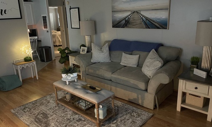 Charlotte Park Casa | Bedroom with a queen size bed and bath. Shared kitchen and lanai.