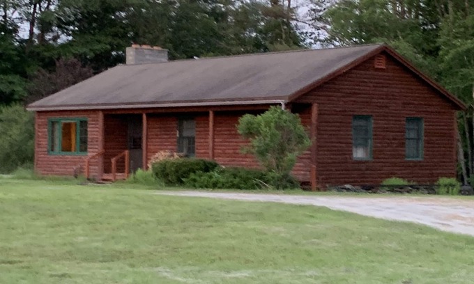 Newport Cabina | Cabin is nestled near the Sugar River in a country setting next to a open field.