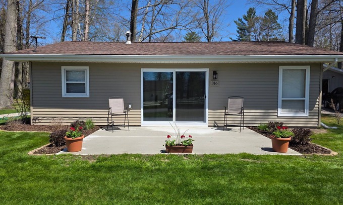 Prudenville Cabaña | Centrally located, four season retreat w/firepit and lakeview.