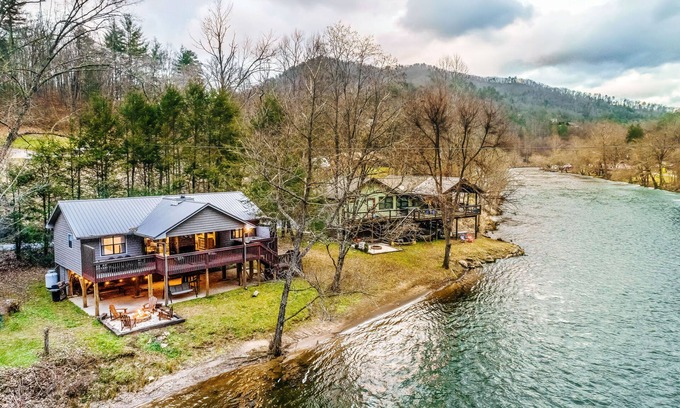 Sylva Casa | Riverfront getaway with a deck, yard, private hot tub, fireplace, and grill