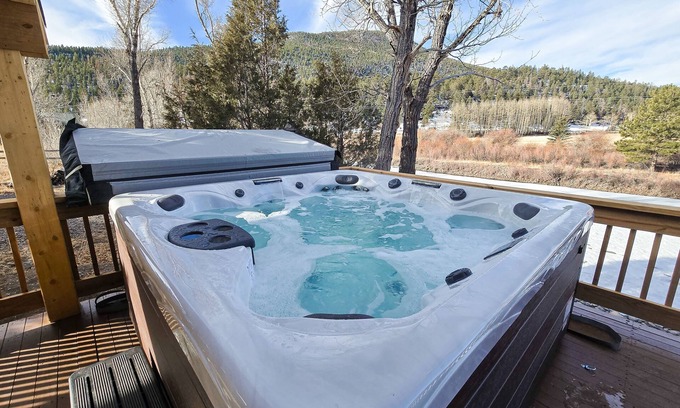 Rio Vista Estates Casa | Charming riverfront cabin with hot tub, fireplace, and stunning outdoor views
