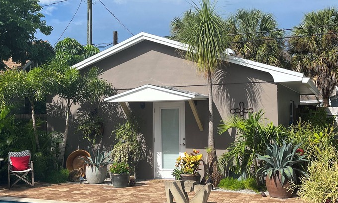 Parrot Cove Cabaña | Chill on the patio overlooking the pool & lush gardens & grill your dinner!