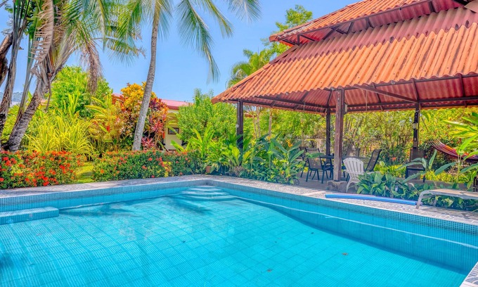 Barrio Ricos y Famosos Casa | Colorful, dog-friendly home with private pool, W/D, & lush setting