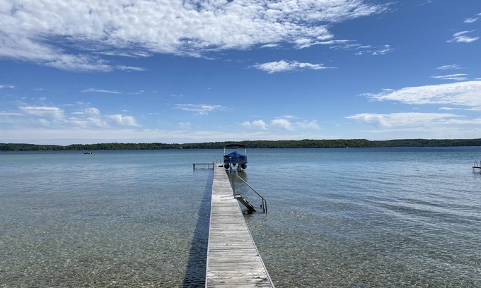 Lake Township Casa | Crystal Lake Waterfront Cottage with Private Dock, Yard, & Hot Tub