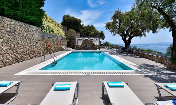 Spartylas Villa | Dazzling Corfu Villa | Villa Poppy | 5 Bedrooms | Breathtaking Sea Views | Spacious Furnished Sun Terrace | Private Outdoor Pool | BBQ Facilities | Shaded Outdoor Dining Area | Children's Playground with Play Equipment | Table Tennis | Spartilas