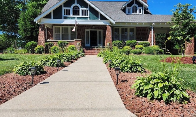 Mount Airy Casa | Enjoy small-town, Main Street from the front porch of this historic bungalow!