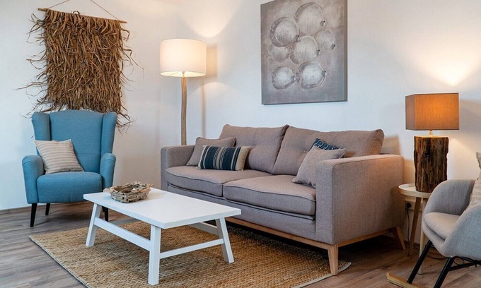 Eilsum Apartamento | Exclusive, modern holiday apartment with a beach chair in the garden