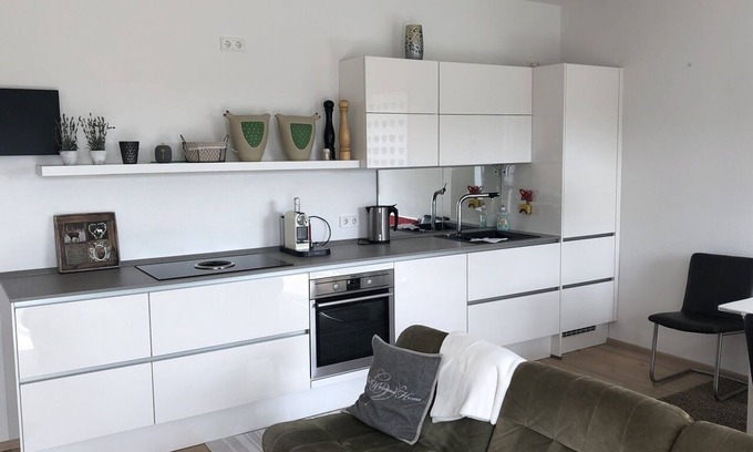 Riedenburg Apartamento | Apartamento con terraza de madera y ducha a ras de suelo para dos personas.