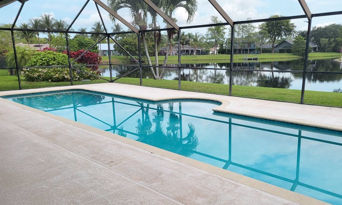 Wellington Casa | Golf cart distance to WEF! Charming 3 bedroom waterfront home with heated pool.