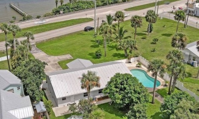 Micco Casa | Indian River Waterfront Home with private dock, heated pool, fenced back yard