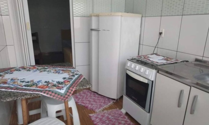 Barra Velha Apartamento | Kitchenette near the beach with air conditioning.