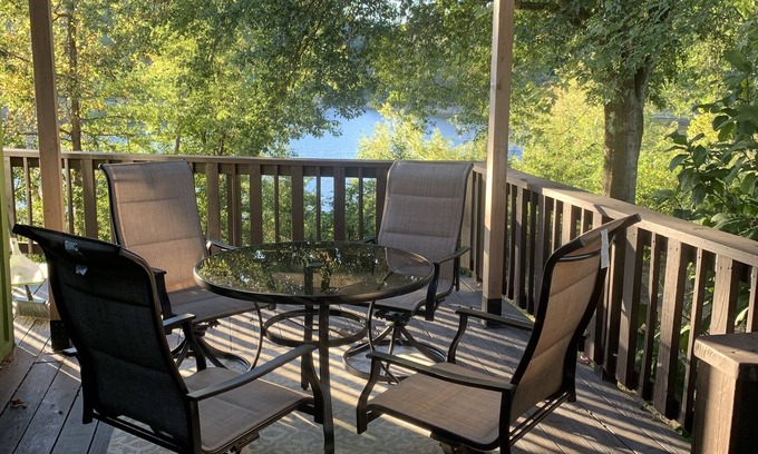 Springdale Casa | Lakeside house with fireplace, deck, and a fenced backyard with firepit.