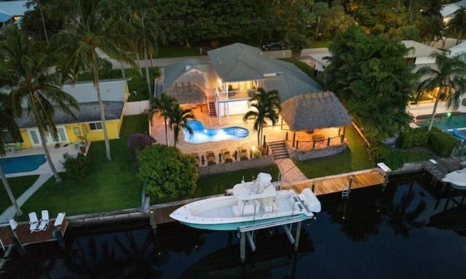 Palm City Casa | Light House Point Canal Front Pool Home with Dock and Ice Machine