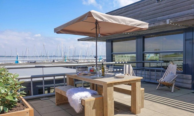 Stellendam Casa | Luxury apartment with private terrace, spacious living room, and stunning views of the marina.