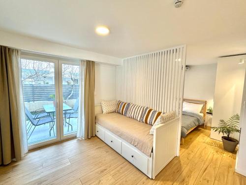 Olymbiaki Akti Casa | Minimalist Seaside Apartment with Private Patio and Parking - Blue Zone Homes