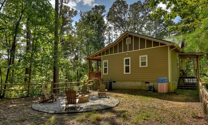 Ellijay Cabina | Mountain Livin' beckons with pet-friendly charm, complete with a fenced yard, soothing hot tub, crackling firepit, and reliable WiFi