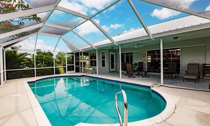 Fort Myers Casa | Offering breathtaking views of the sun setting over the water.