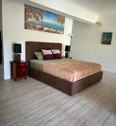 Gold Coast Casa | One bedroom with shared bathroom ground level of a two-story house