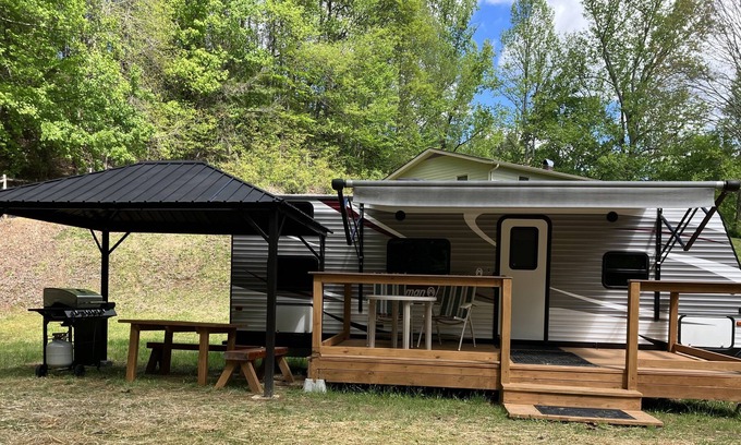 Brevard Casa | Rader Retreat RV/Camper cozy spot to sit out on the deck after a day of hiking.