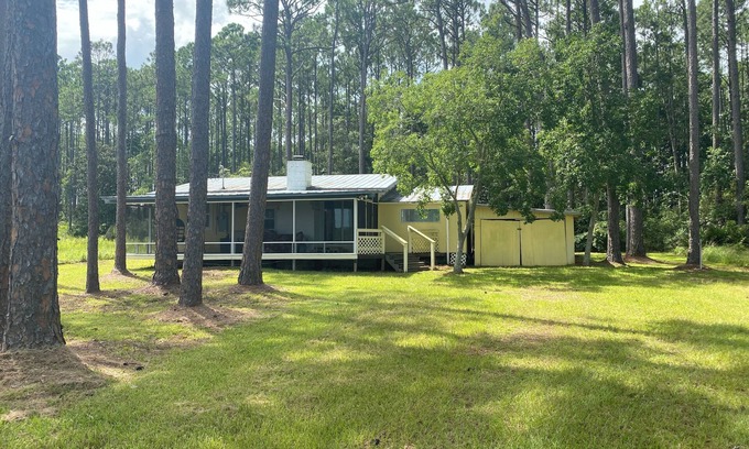 Carrabelle Cabaña | Remodeled historic cottage with a peek of the Gulf of Mexico.