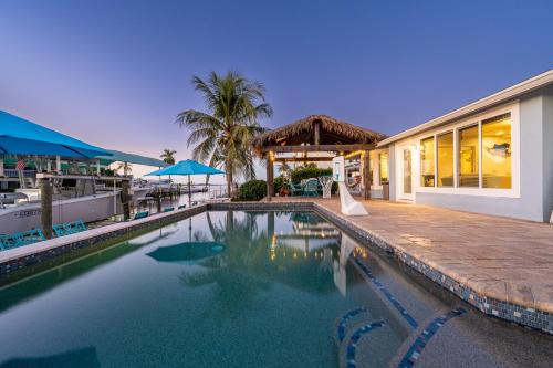 Whitney Beach Casa | Royal Palm Paradise! Waterfront, Private Pool & Hot Tub, Boat Dock!
