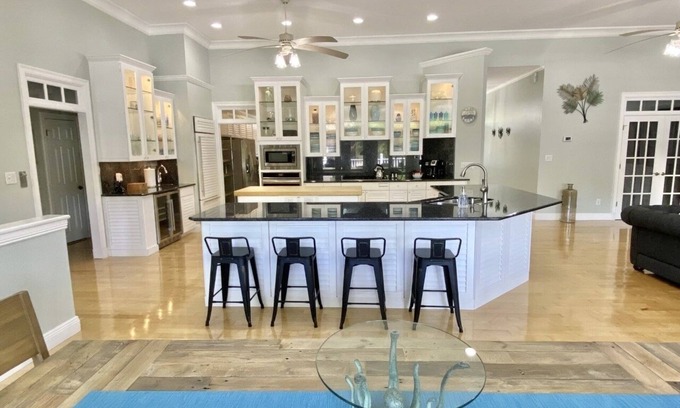 Gulf Breeze Casa | Salty Pelican Retreat on Canal with Pool, Elevator and Boat Dock