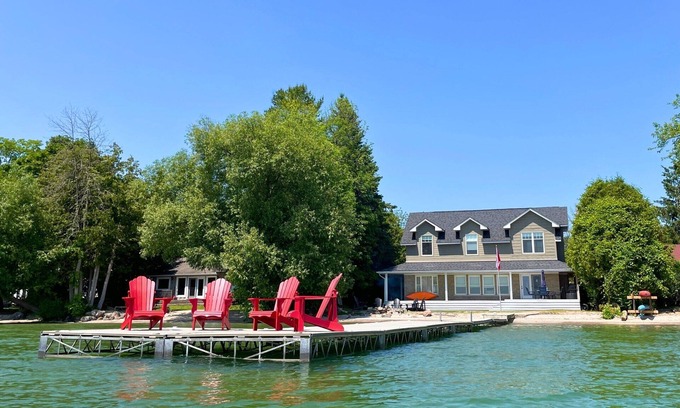 Big Bay Point Cabaña | Shallow Beach Lakefront Cottage perfect with Kayak, Firepit, BBQ + Playground