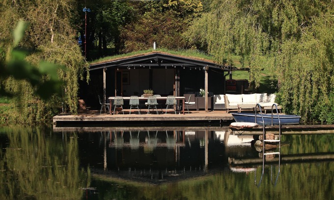 South Brent Cabina | Sitting on the edge of a lake by itself.
