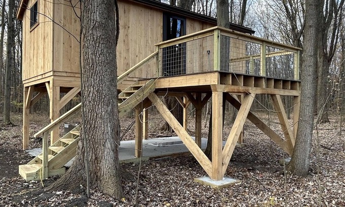 Girard Cabina | Timber framed tree cabin nestled in the woods.