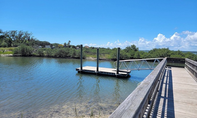 Butler Beach Cabaña | Wake up to an amazing sunrise from your wood deck with outdoor furniture