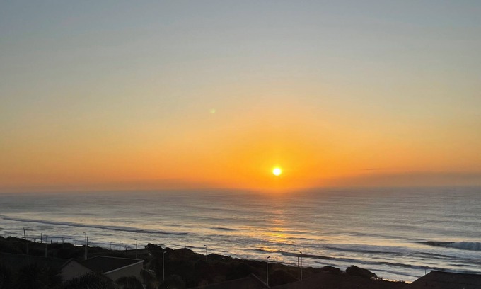 Warner Beach Cabaña | Wake up to gorgeous sunrises and sea views upon a wooden balcony.