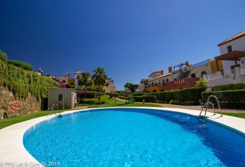 Costa Esuri Casa | (WAR002) Town House with Garden and Pool Access