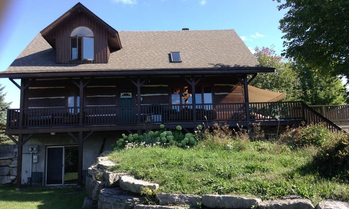 North Algona Wilberforce Cabaña | Waterfront log home on Lake Dore. Decks, dock, outdoor hot tub and fire pit.