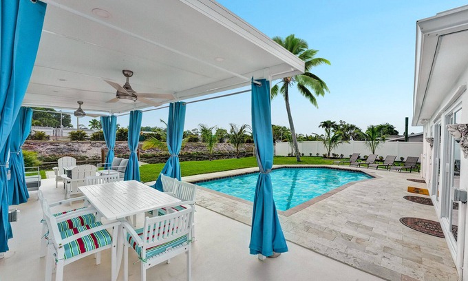 Golfview Harbor Casa | Waterfront Tropic Oasis: Heated Pool, Pergola, Canal, Dock, Air Hockey!