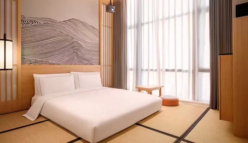Habitación de estilo japonés con una cama doble, vistas a la ciudad