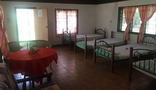 Dormitorio compartido básico, varias camas, vistas parciales al mar, planta baja