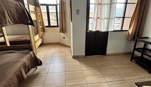 Dormitorio compartido económico, varias camas, balcón, vistas a la ciudad