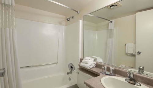 Efficiency 3 Queen Bed Non-Smoking Room with kitchenette and dining area