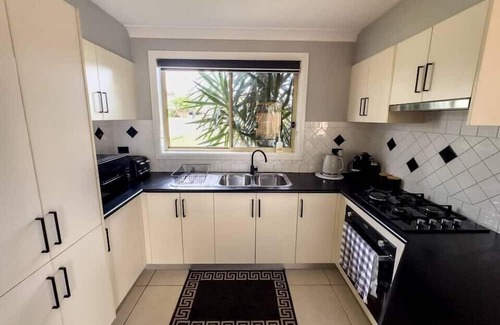 Prestons Casa | KozyGuru | Prestons Dream Holiday House + Parking
