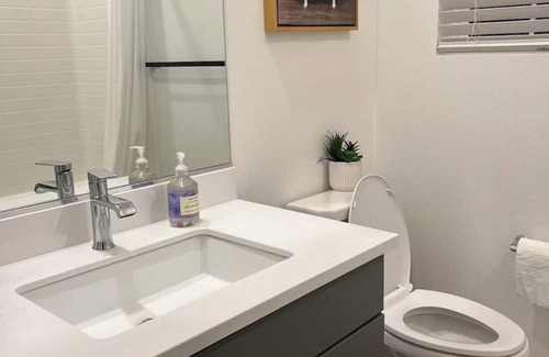 Upland Casa | Beautiful bedroom 02 with a private bathroom featuring a tub and shower.