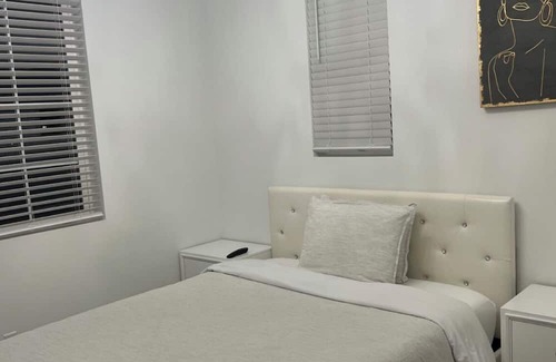 Upland Casa | Beautiful bedroom 02 with a private bathroom featuring a tub and shower.
