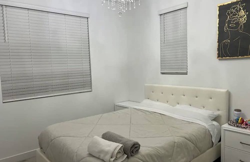 Upland Casa | Beautiful bedroom 02 with a private bathroom featuring a tub and shower.