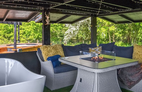 Storwood Cabaña | We just love the outside entertainment area with a bath for two, table top fire pit and large Smart
