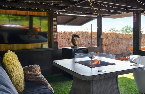 Storwood Cabaña | We just love the outside entertainment area with a bath for two, table top fire pit and large Smart